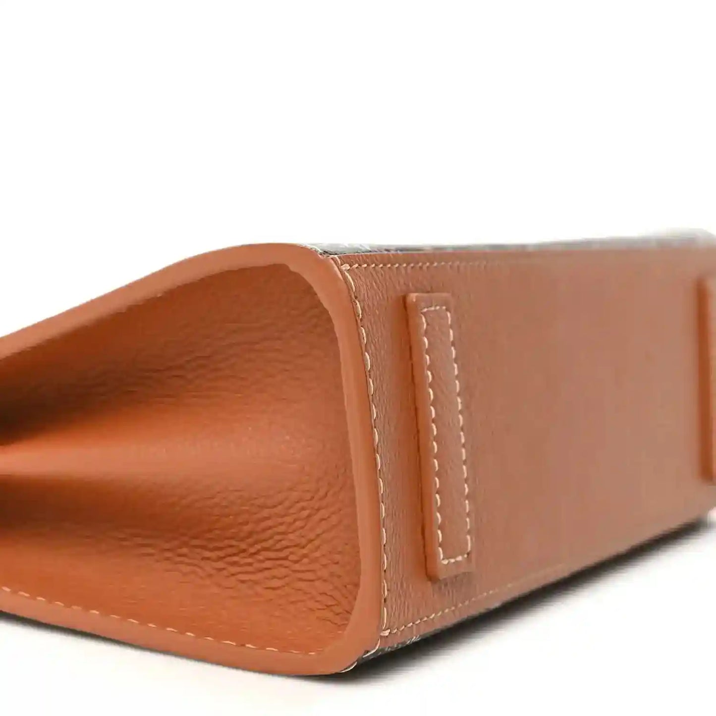 Mini tote bag tan leather base panel with visible grain texture and stitched trim