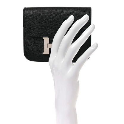 Black slim leather wallet front H clasp with hand for scale