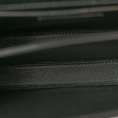 Black leather bag interior seam and textured lining detail.
