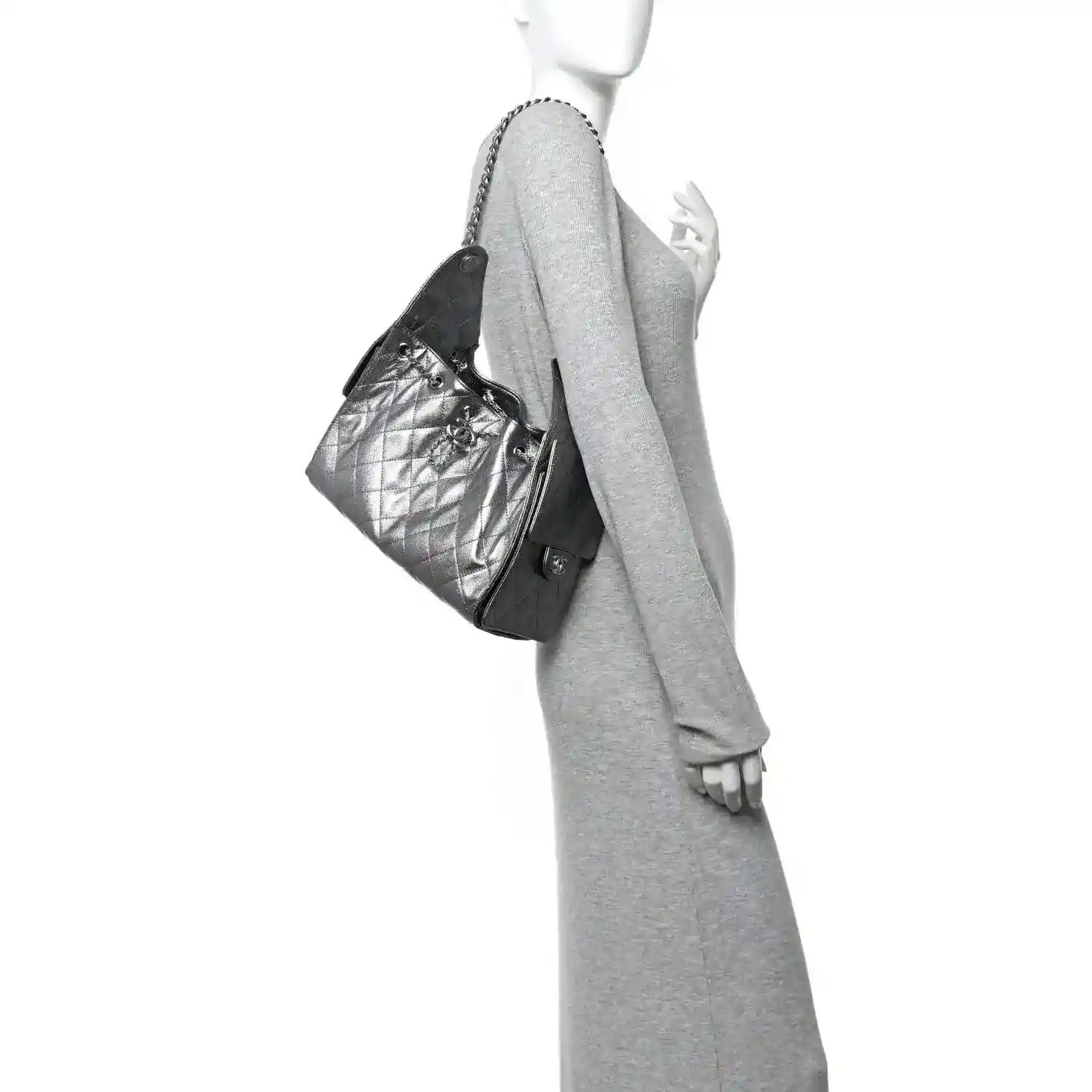 Chanel metallic caviar quilted handbag with chain strap, worn at side