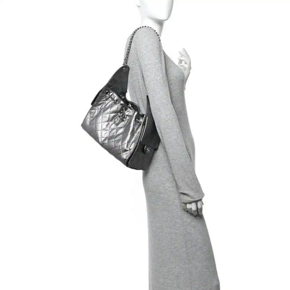 Chanel metallic caviar quilted handbag with chain strap, worn at side