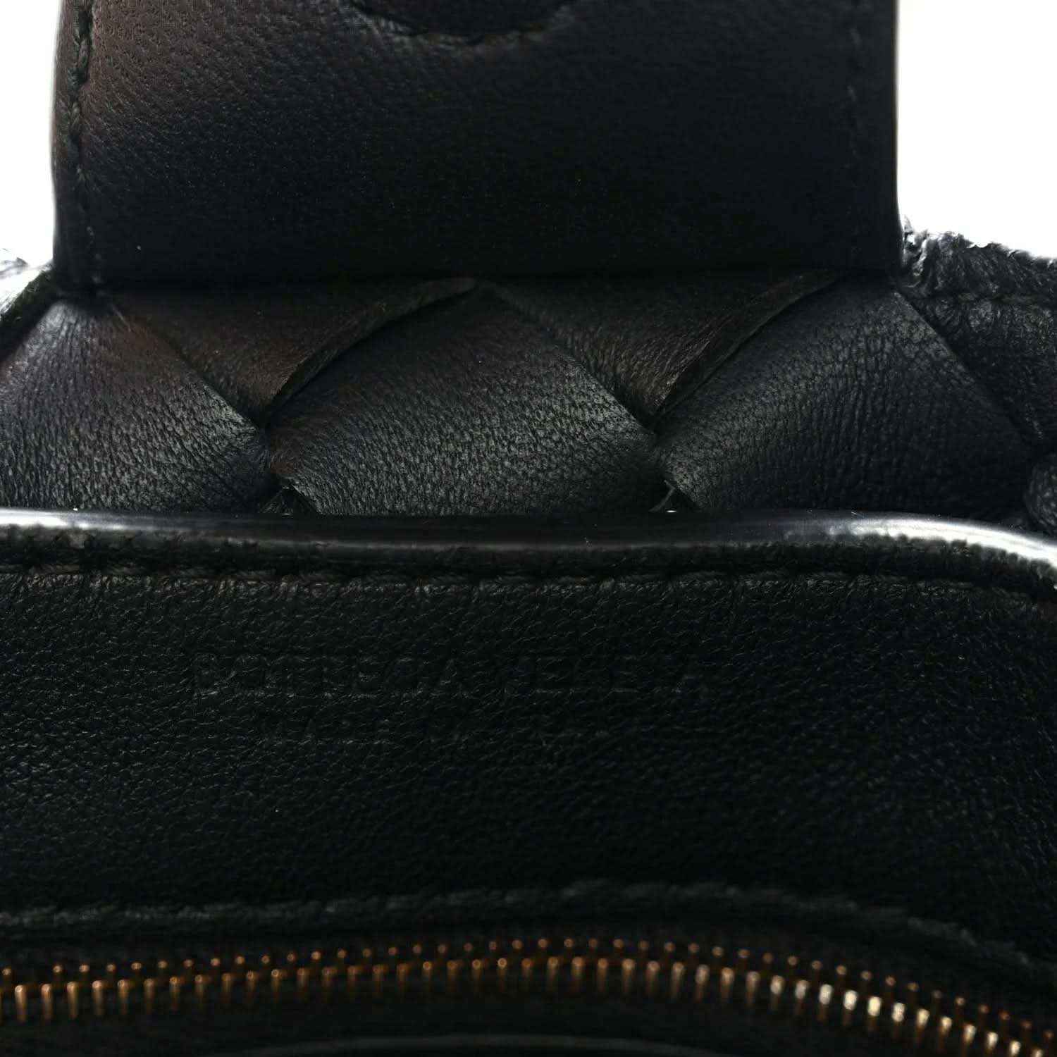 Black leather zipper opening with quilted weave detail