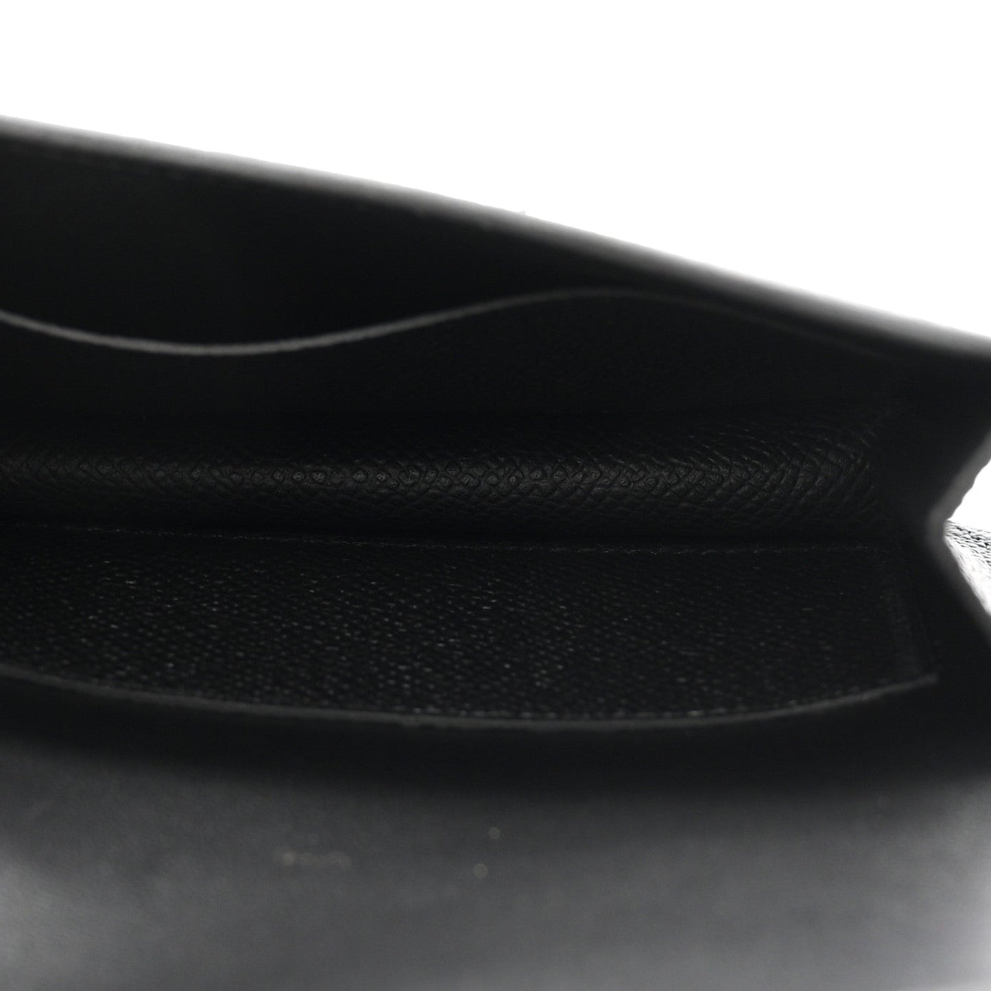 Black leather wallet interior with stitched edge and soft lining.