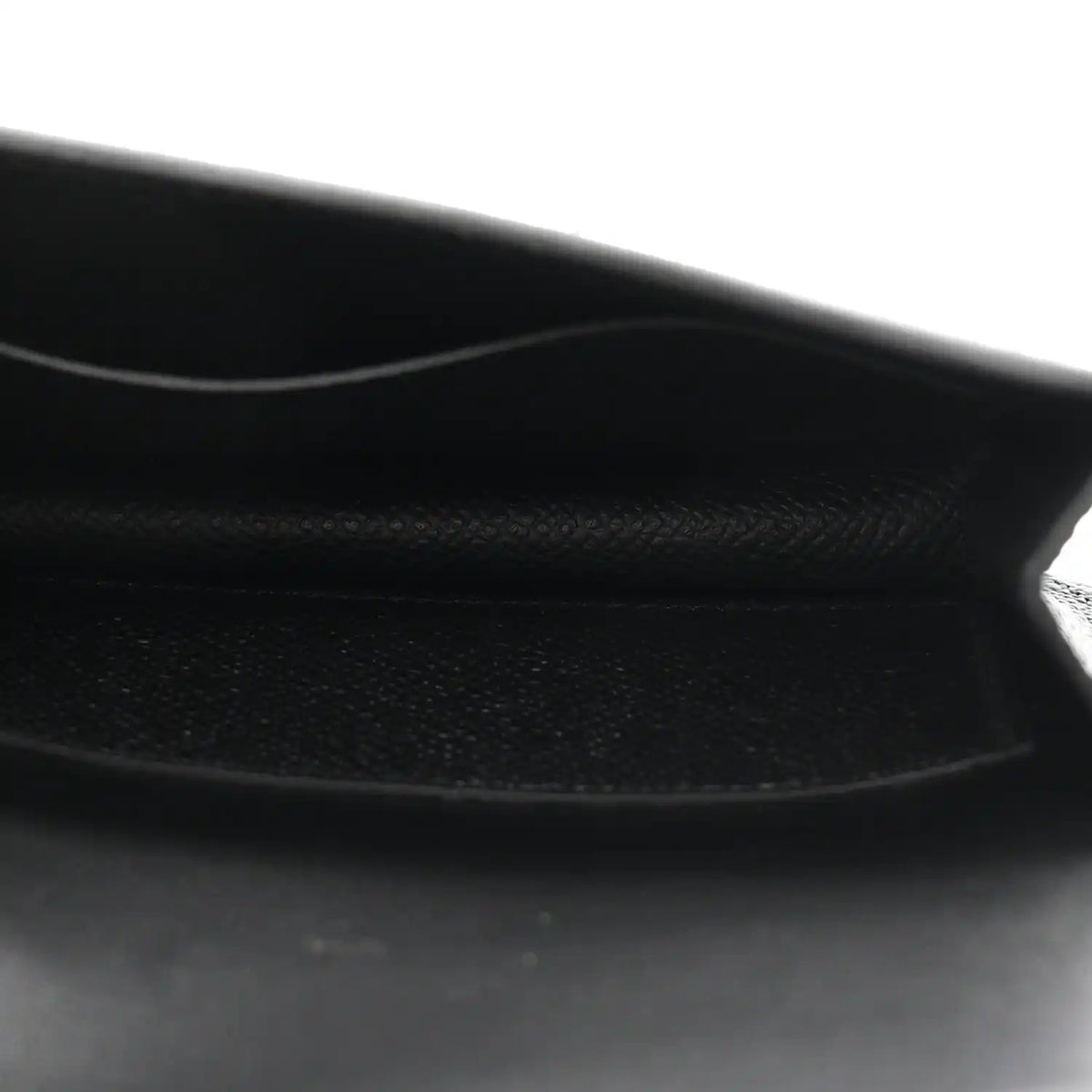 Black leather wallet interior with stitched edge and soft lining.