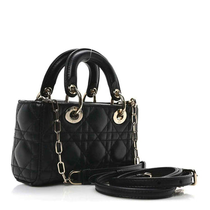 Black quilted mini handbag with top handles, chain strap, and gold-tone hardware