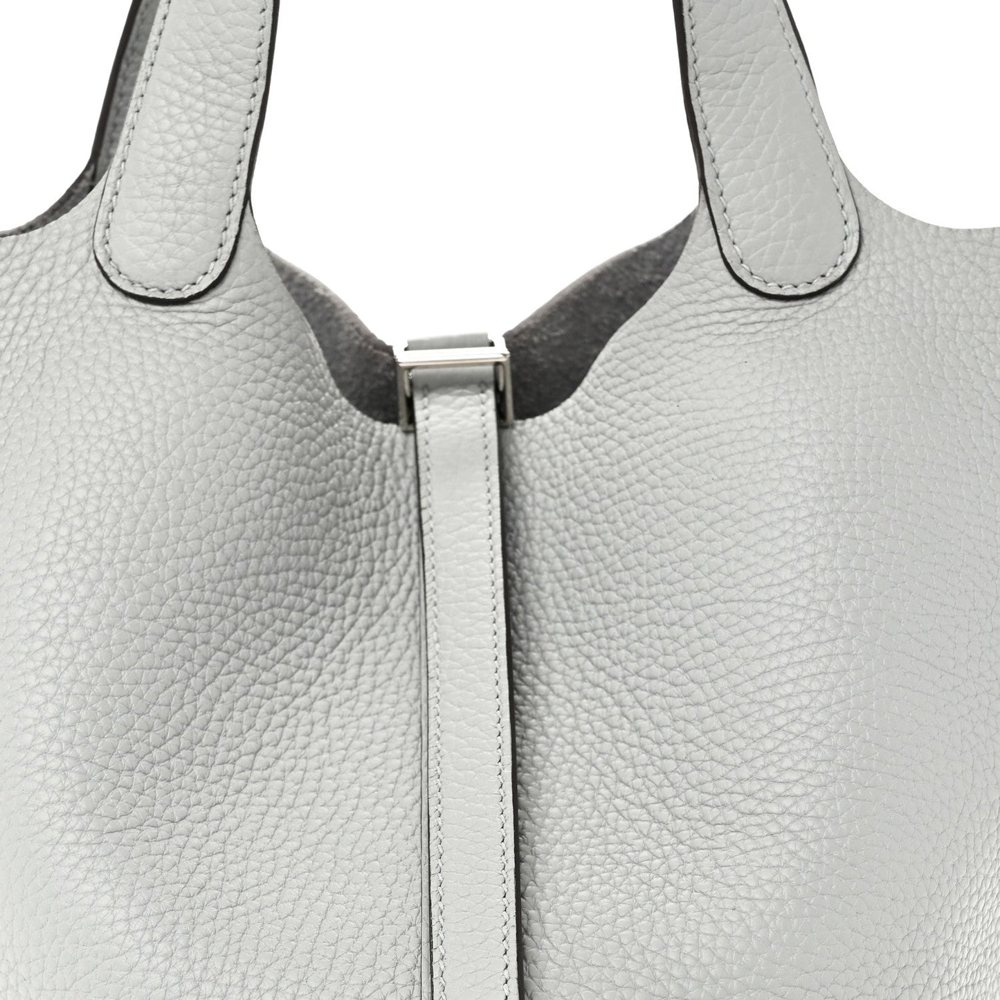 Close-up of light blue pebbled leather tote top with front lock and stitched edges