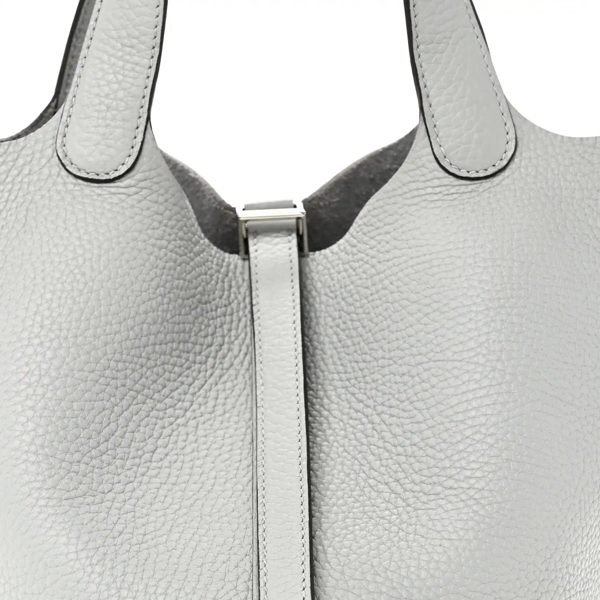 Close-up of light blue pebbled leather tote top with front lock and stitched edges