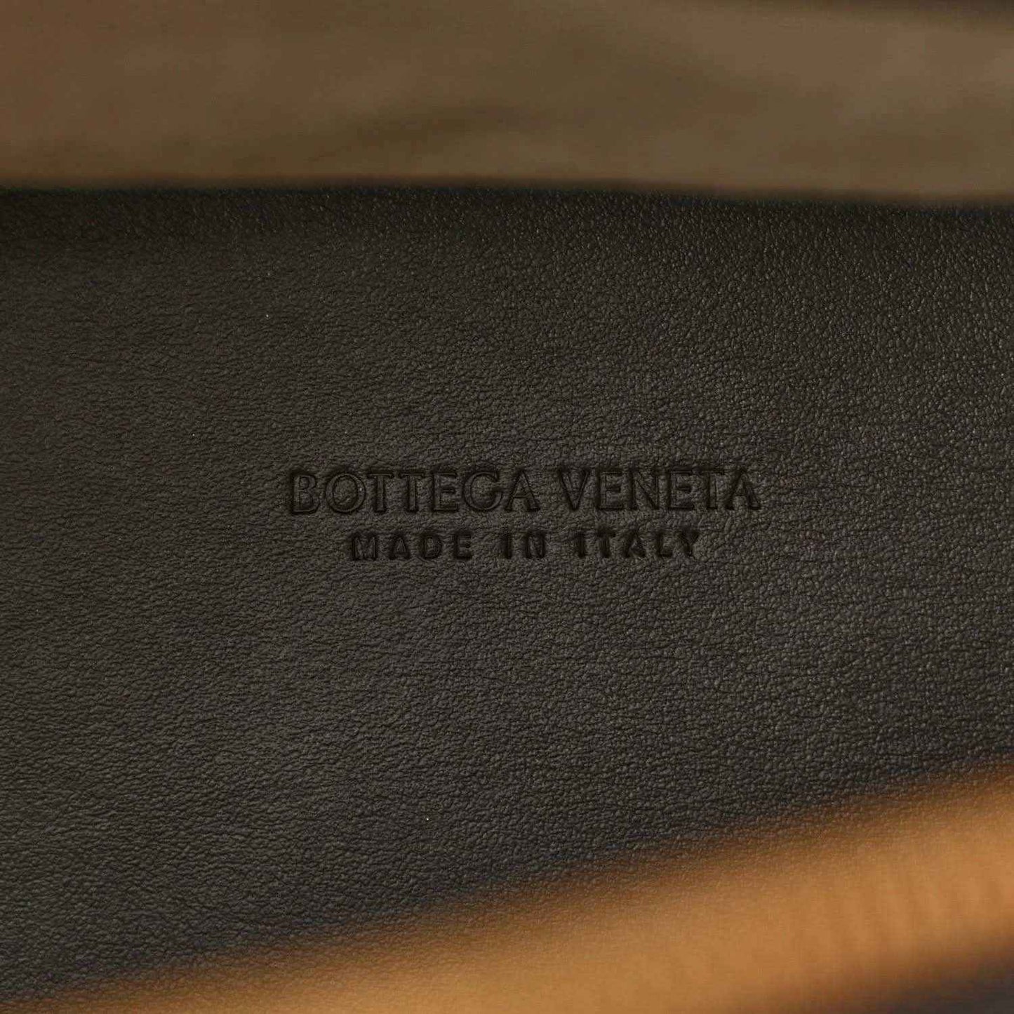 Bottega Veneta embossed on black leather weekender bag lining