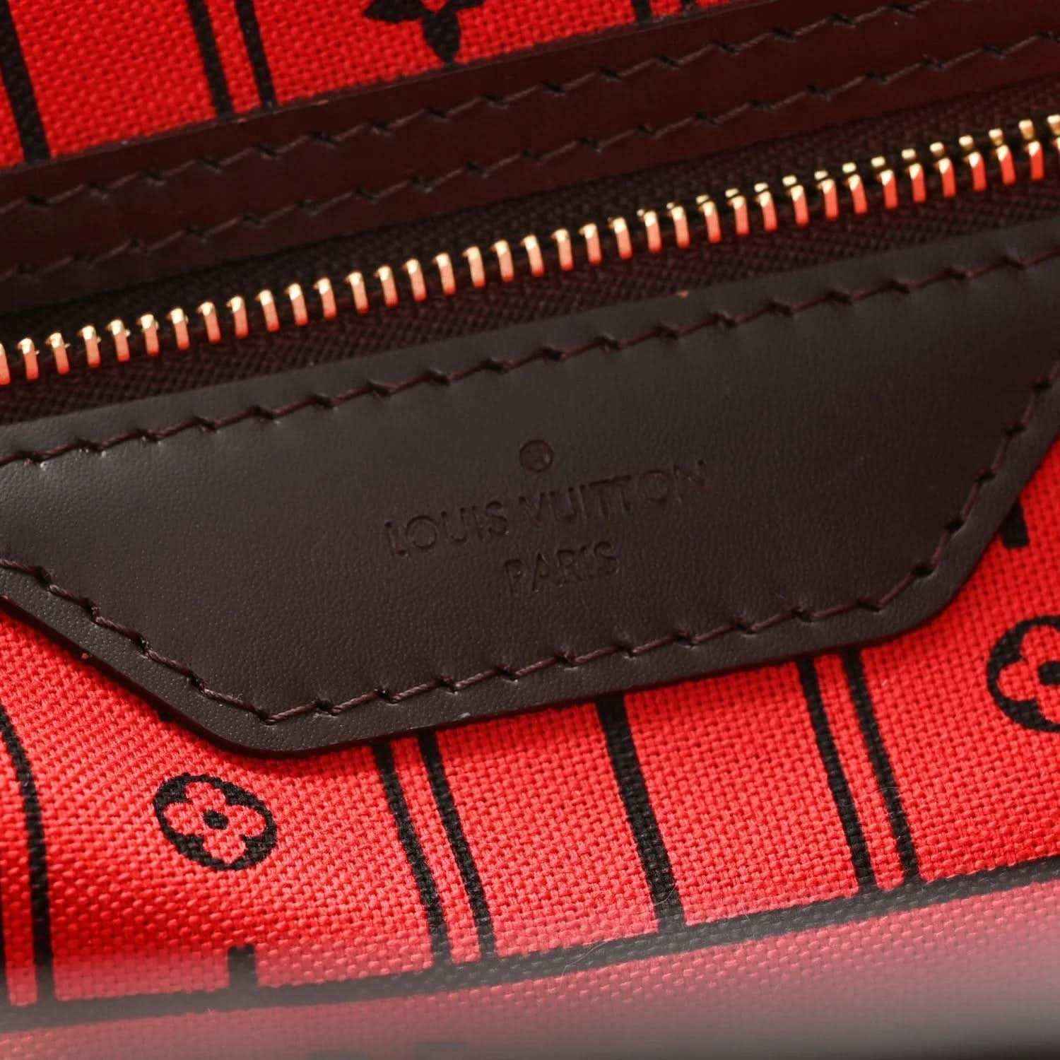 Damier Ebene tote bag interior zip pocket with stitched leather trim and logo mark