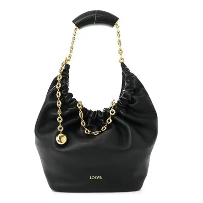 Loewe small squeeze bag in black ruched nappa leather with gold chain handle