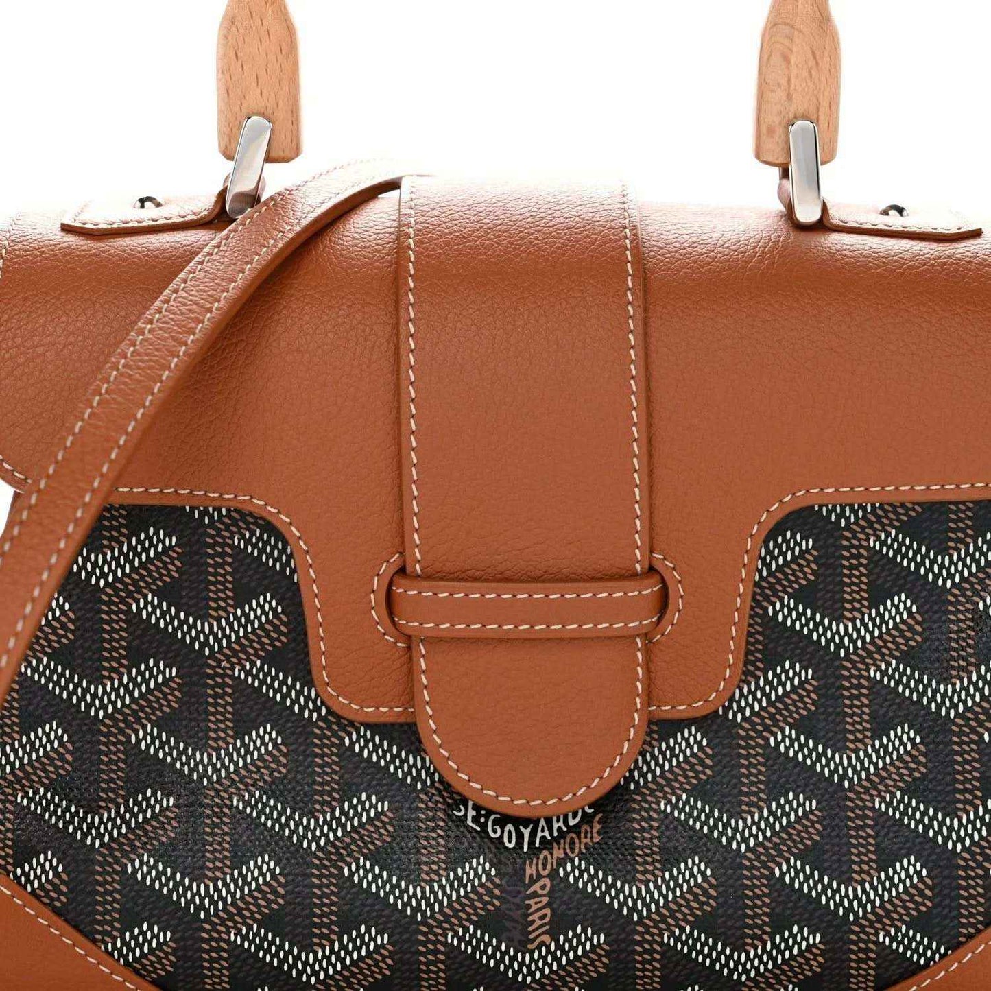 Mini shoulder bag front with tan leather flap and dark patterned canvas side panels