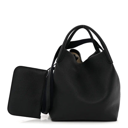 Large dark navy tote bag with grained finish, top handles, and side pocket