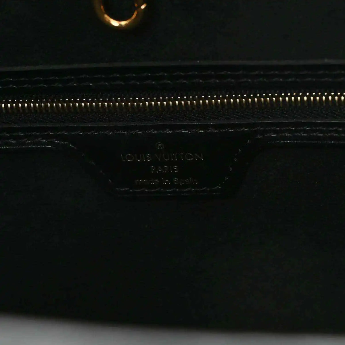 Black leather pouch base with Louis Vuitton logo stamp and gold zipper track