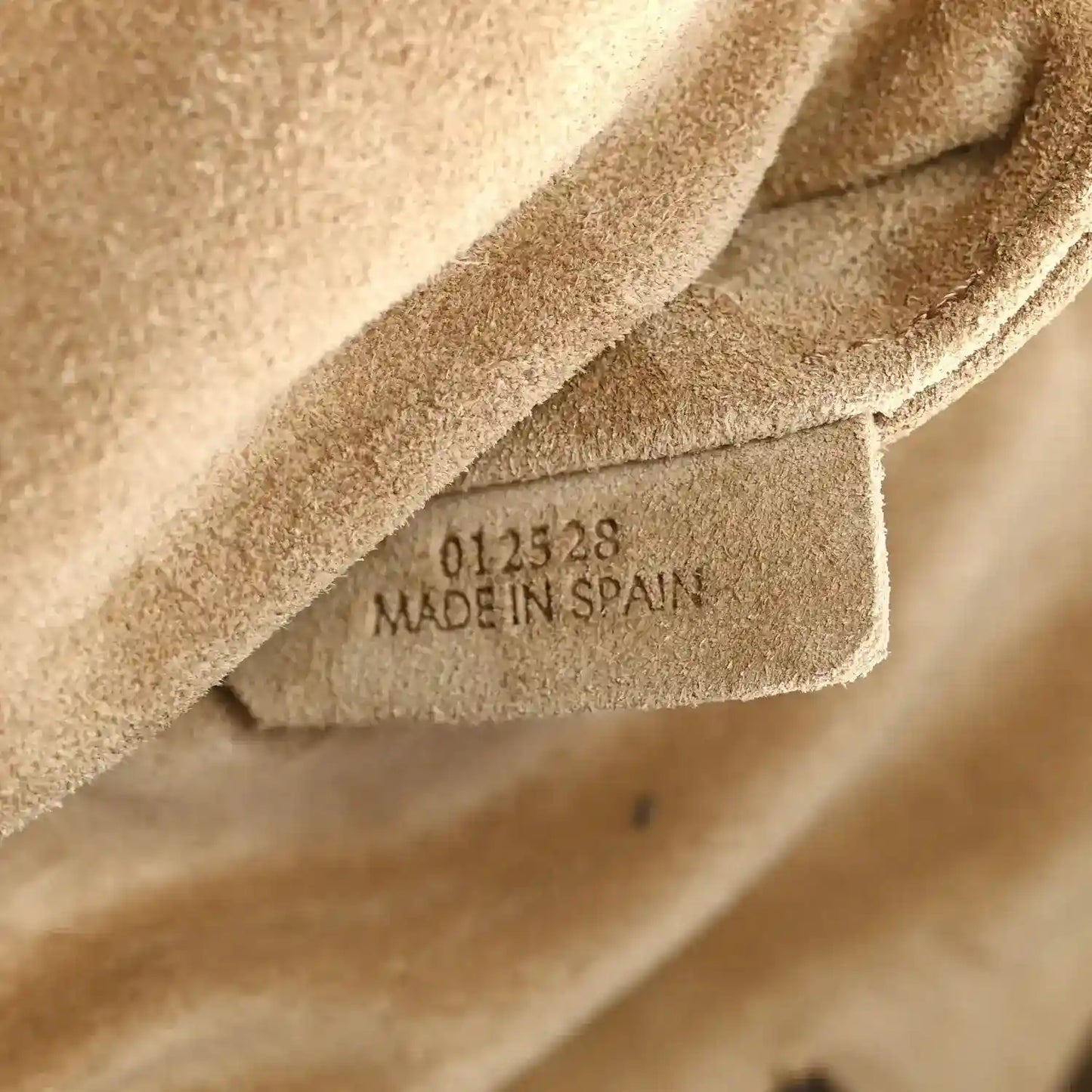 Tan suede interior with stamped code text reading “MADE IN SPAIN”.
