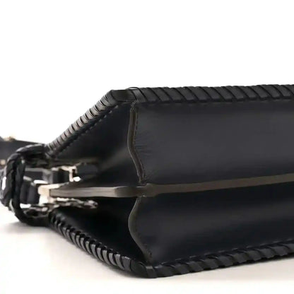 Nappa satchel side view with leather trim and braided crossbody strap