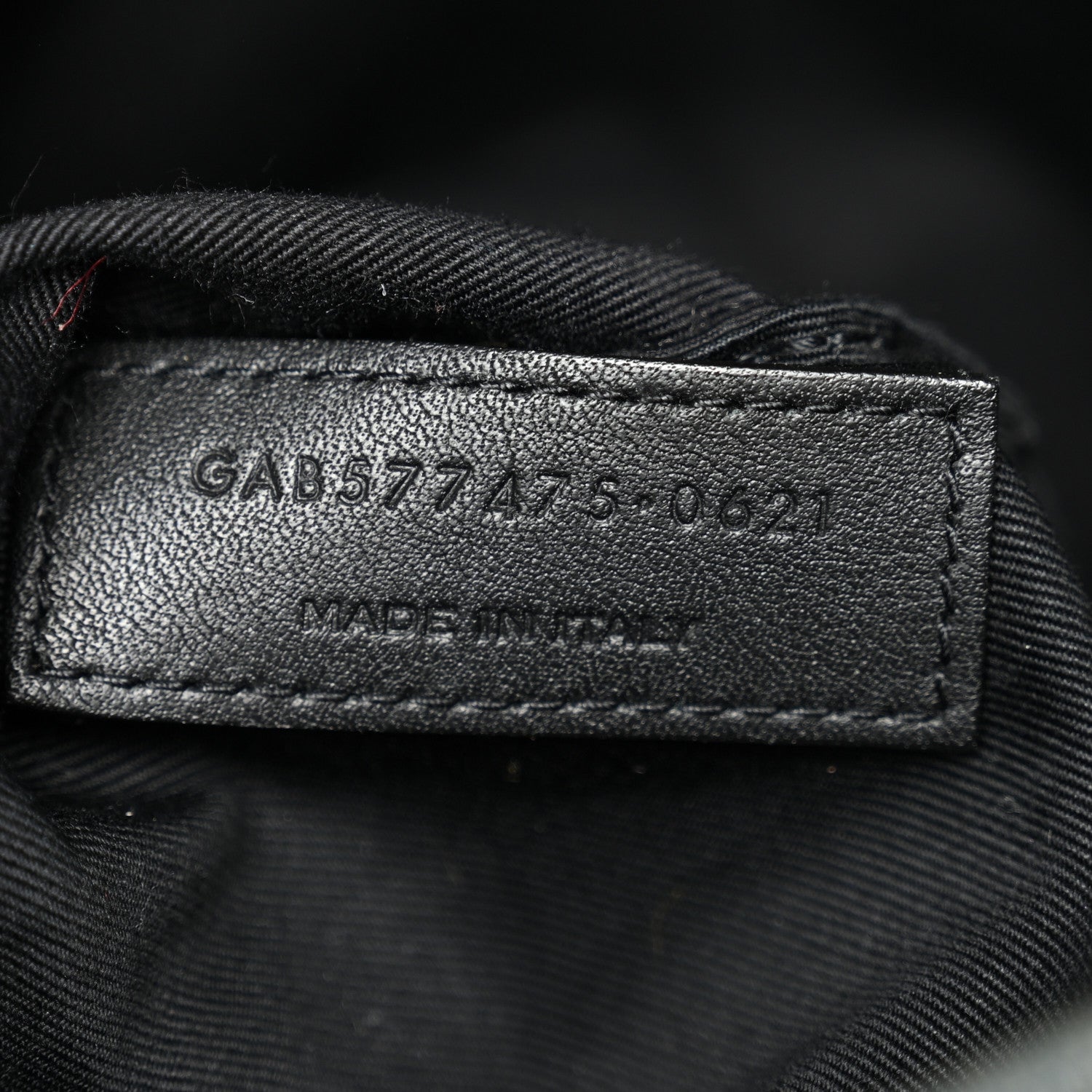 Leather size tag inside denim satchel with stamped numbers