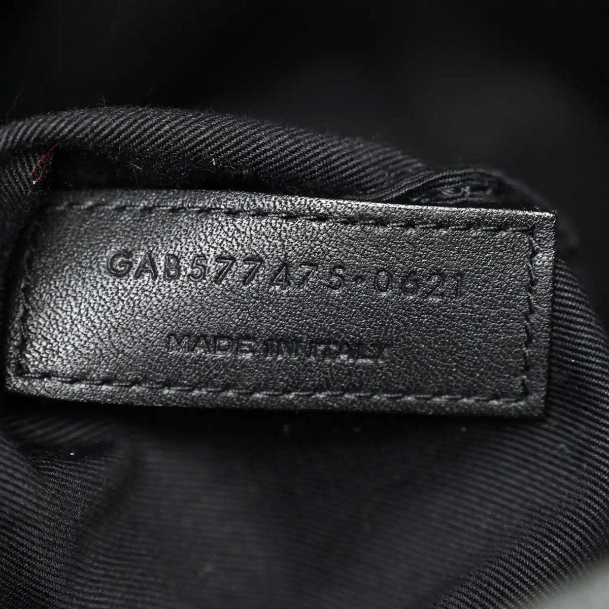Leather size tag inside denim satchel with stamped numbers