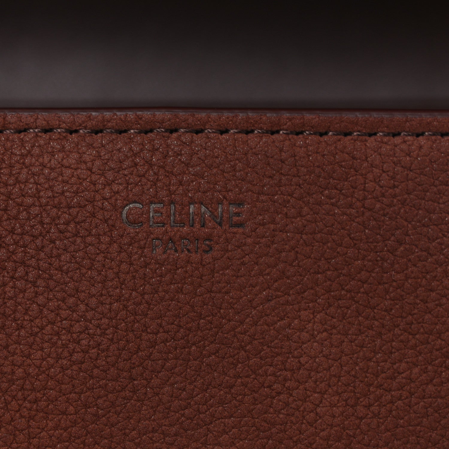 Brown grained leather panel with 'CELINE PARIS' stamp.