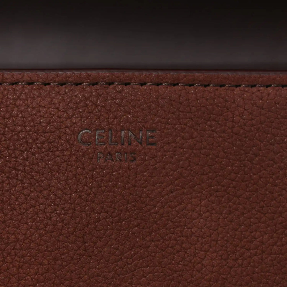 Brown grained leather panel with 'CELINE PARIS' stamp.