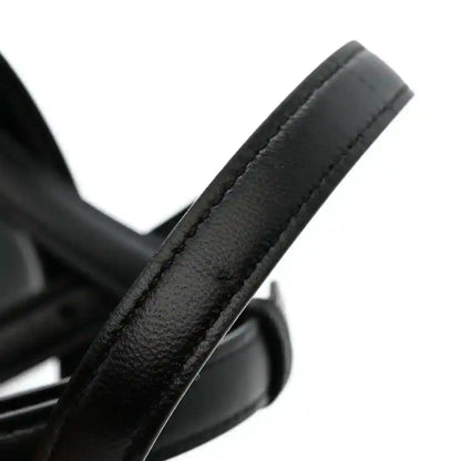 Black leather satchel handle end with metal ring detail
