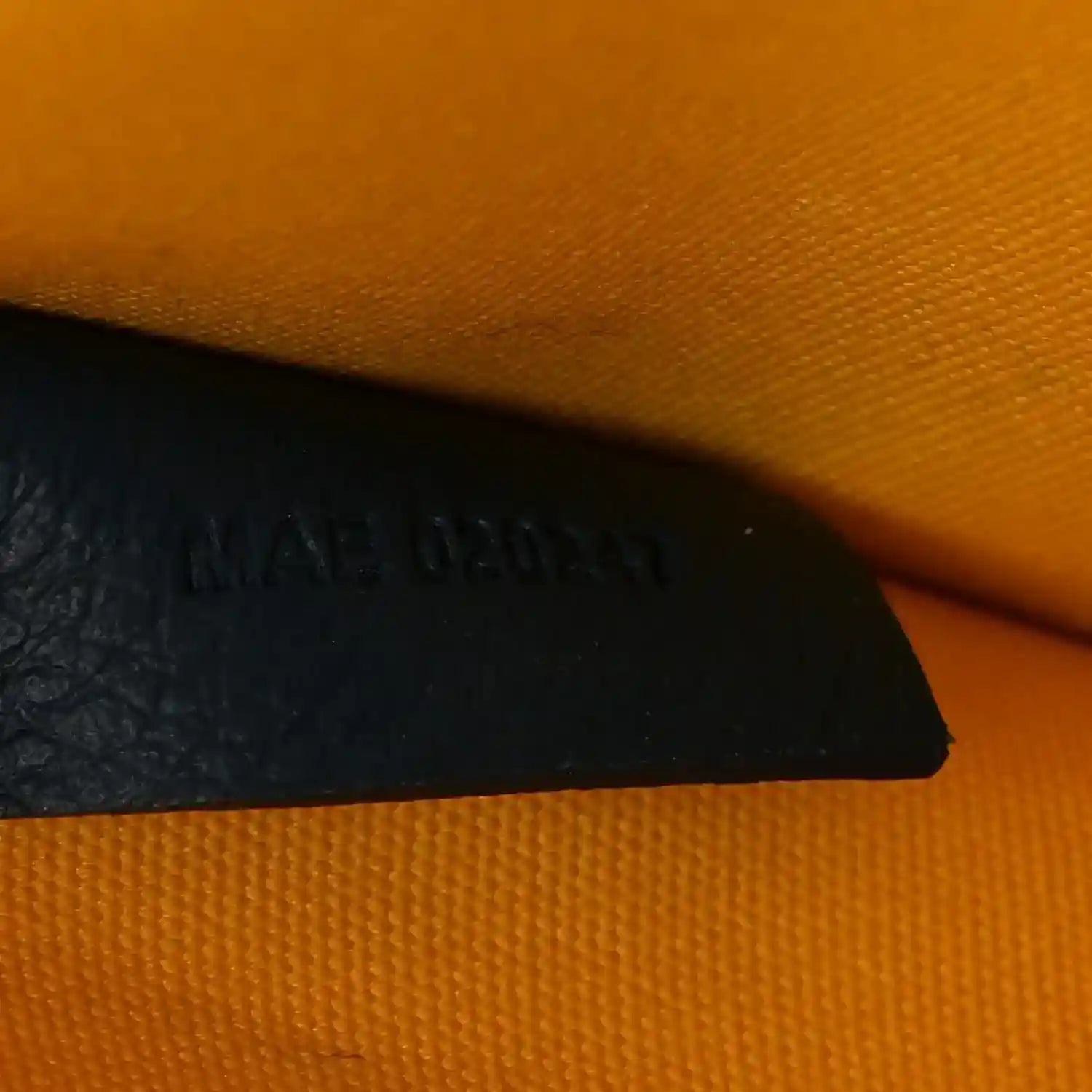 Villette PM tote interior corner with dark panel and embossed brand text on lining.