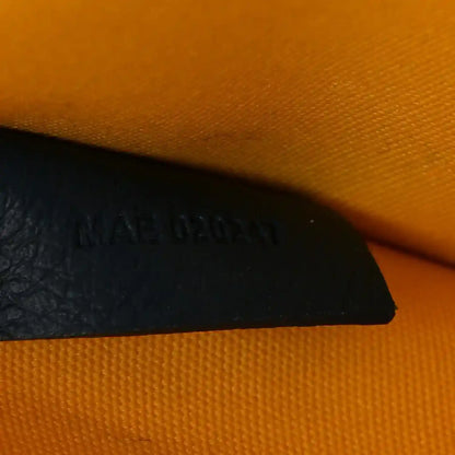 Villette PM tote interior corner with dark panel and embossed brand text on lining.