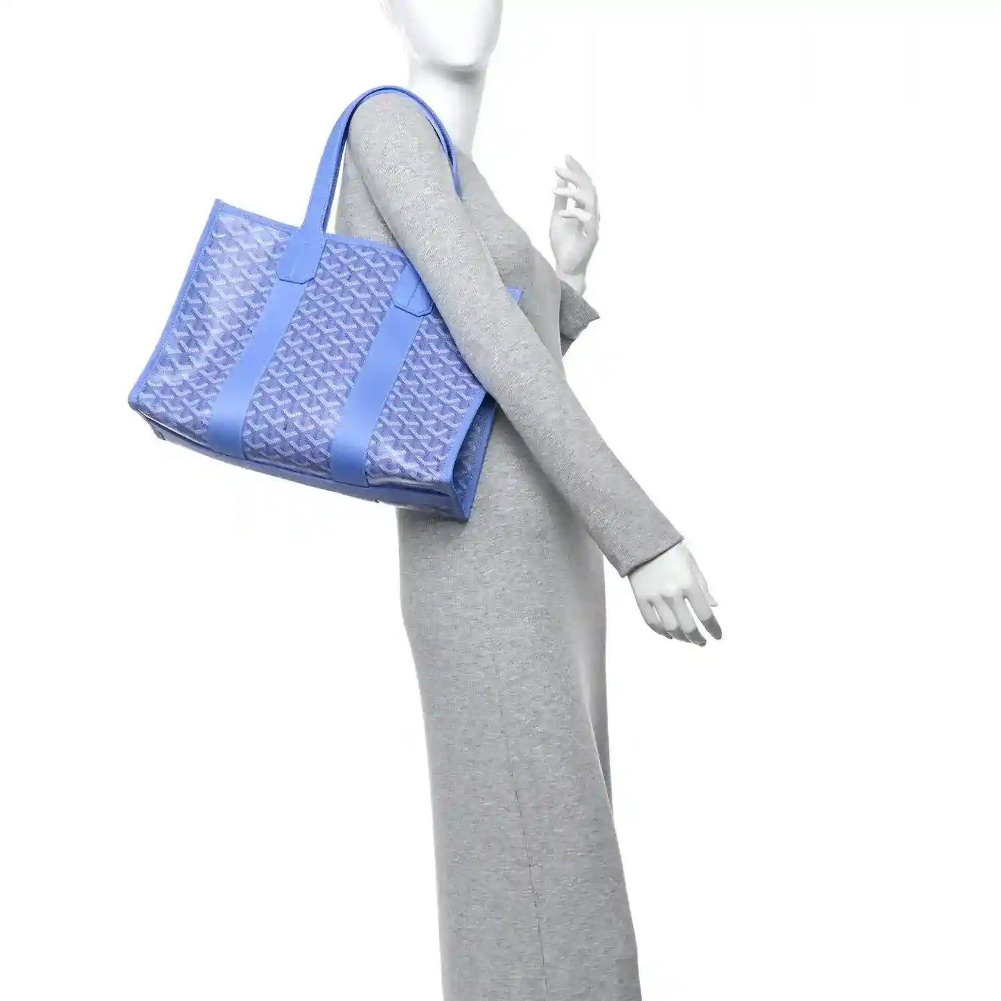 Goyardine Villette PM tote bag held by mannequin, blue coated canvas with short handles
