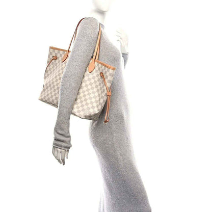 Damier Azur tote bag with tan leather trim, carried on shoulder