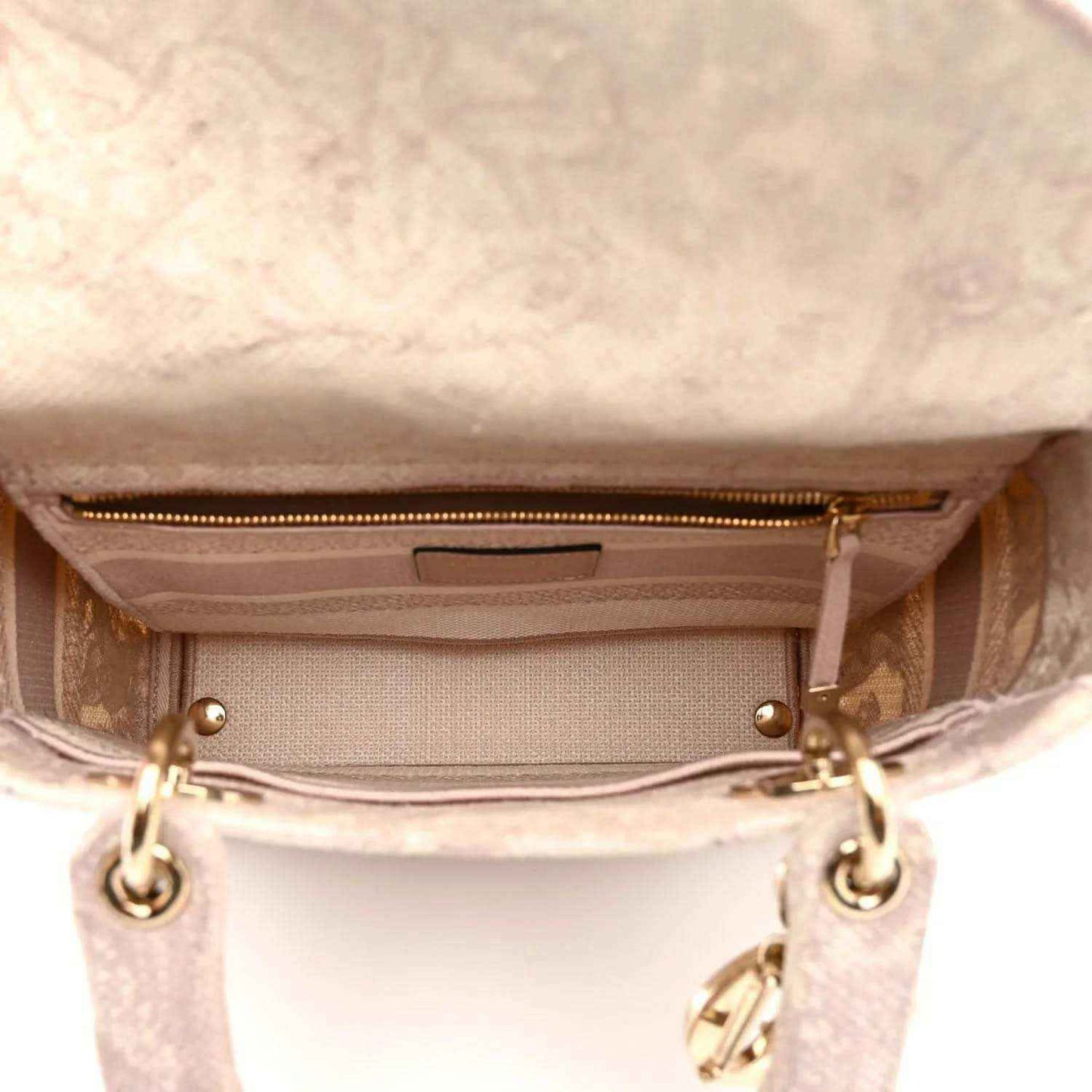 Rose-pink handbag interior view with top zipper and fabric lining, gold-tone hardware