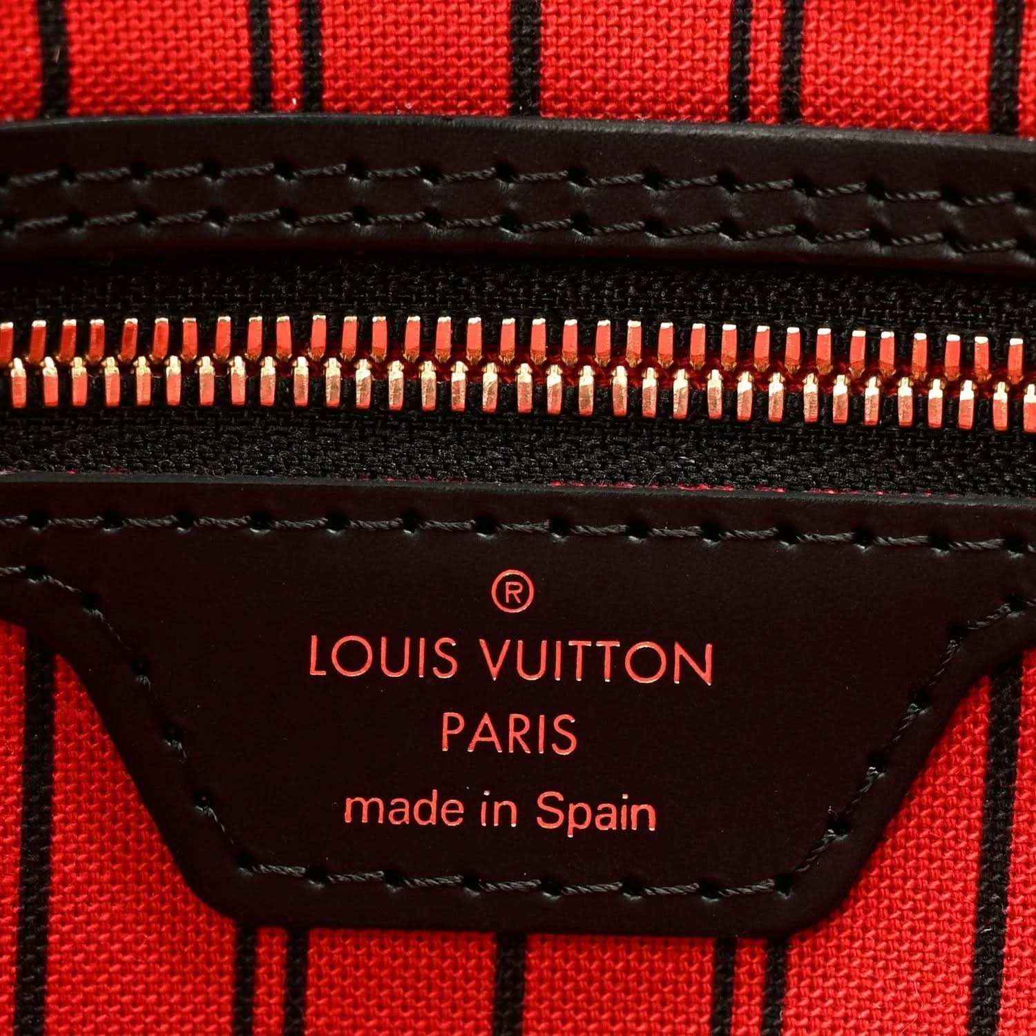 Red lining label reading Louis Vuitton Paris made in Spain with zipper close-up