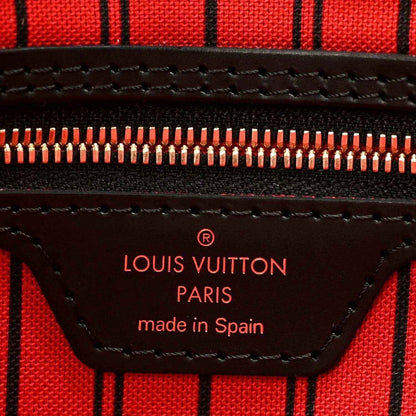 Red lining label reading Louis Vuitton Paris made in Spain with zipper close-up
