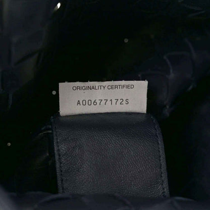 Black leather bag originality label reading "ORIGINALITY CERTIFIED" with code