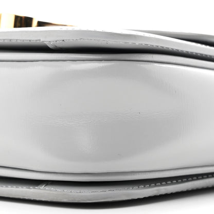 Shiny calfskin bag bottom edge with stitching and layered construction close-up