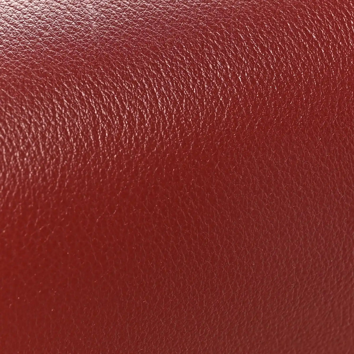 Light burgundy grained calfskin bag leather texture close-up