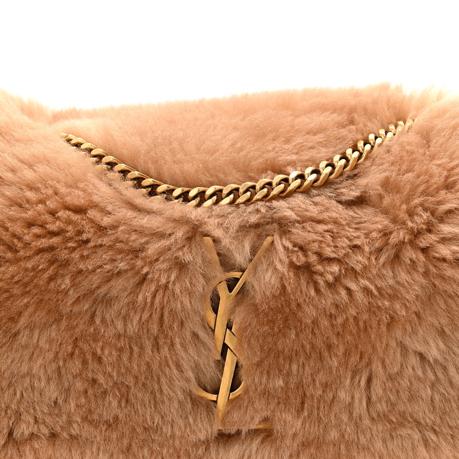 Saint Laurent reversible satchel with tan shearling, toggle closure, and gold chain