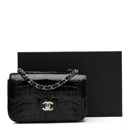 Chanel mini rectangular flap bag in shiny black alligator with chain strap and CC clasp