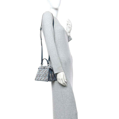 Small jacquard satchel worn crossbody, blue velvet with tan FF pattern and shoulder strap