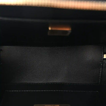 Black leather bag interior with zipper opening and gold-tone hardware detail