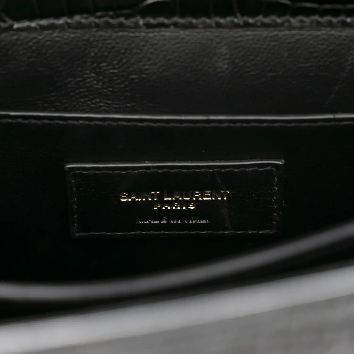 Black leather interior label reading SAINT LAURENT PARIS