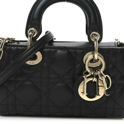 Black quilted mini handbag front with CD emblem, handle rings, and gold-tone clasp