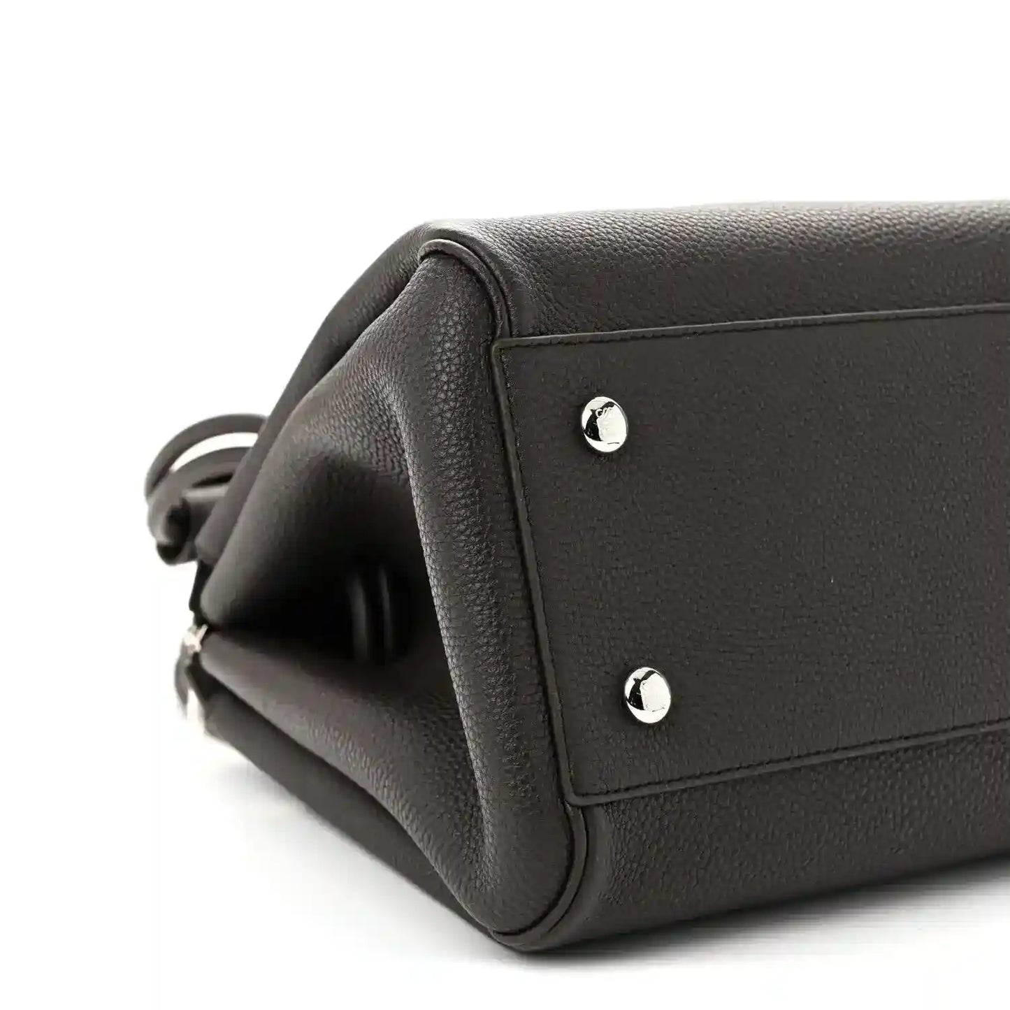 Dark leather Loewe Madrid bag corner with silver stud accents and top handle