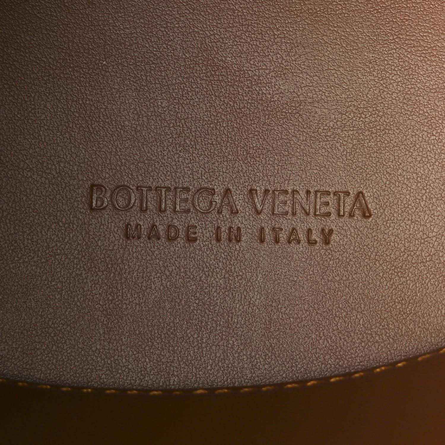 Amber suede exterior panel with 'Bottega Veneta' and 'Made in Italy' embossing