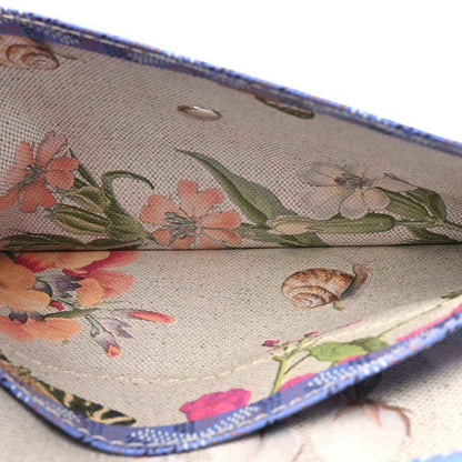 Goyardine tote bag interior pocket detail with floral print and blue trim