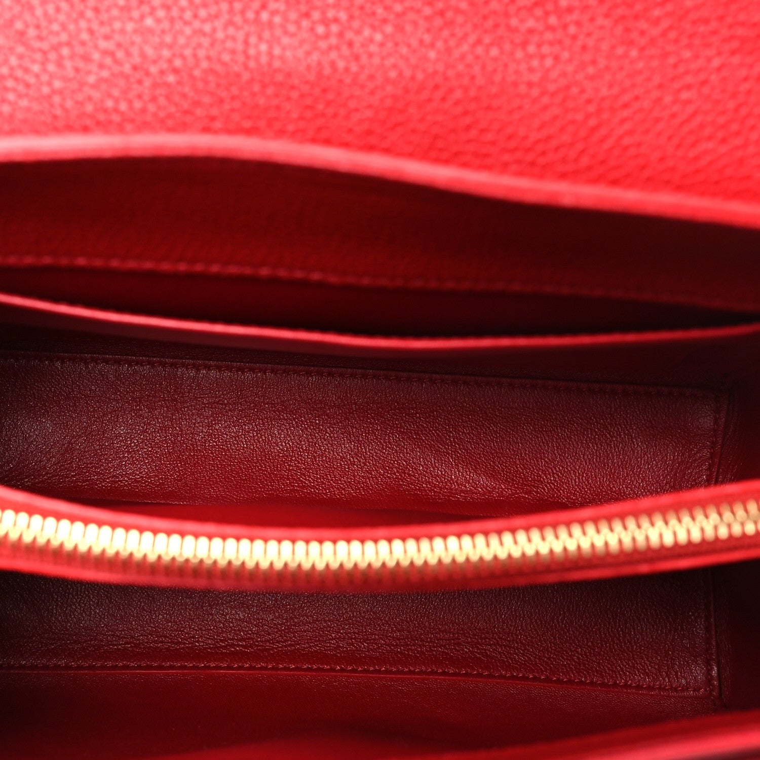 Celine red leather interior with stitched lining and zipper edge.