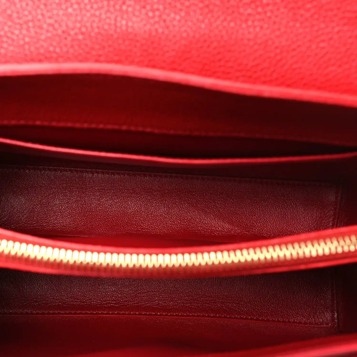 Celine red leather interior with stitched lining and zipper edge.