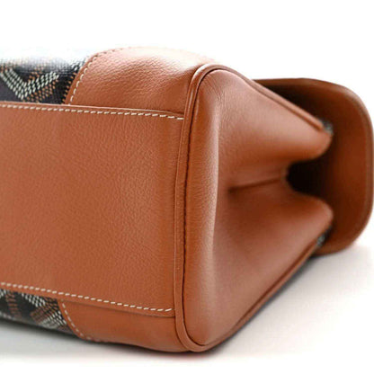 Mini shoulder bag end with tan leather fold-over edge and dark patterned canvas
