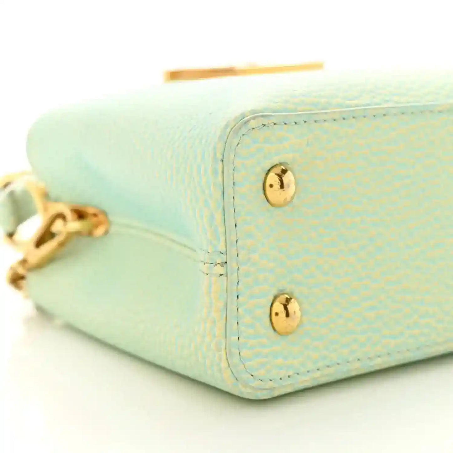 Mini Capucines handbag in light green textured leather with gold corner studs