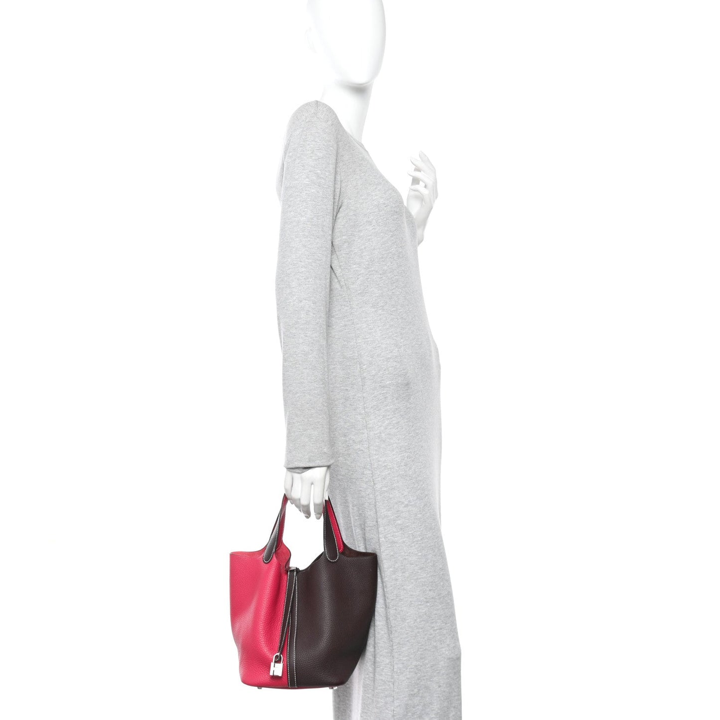 Two-tone bucket bag with bright red body and dark brown sides, top handles, zip closure