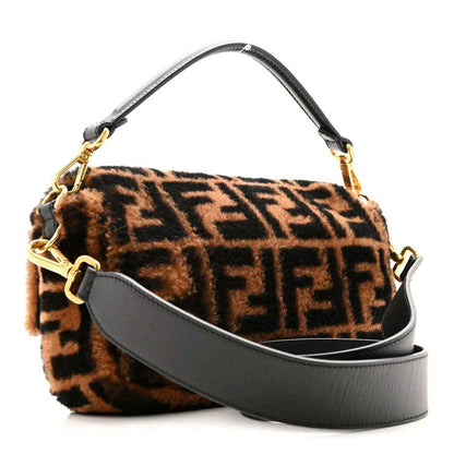 Brown shearling Baguette bag with black FF motif, leather strap, gold hardware.