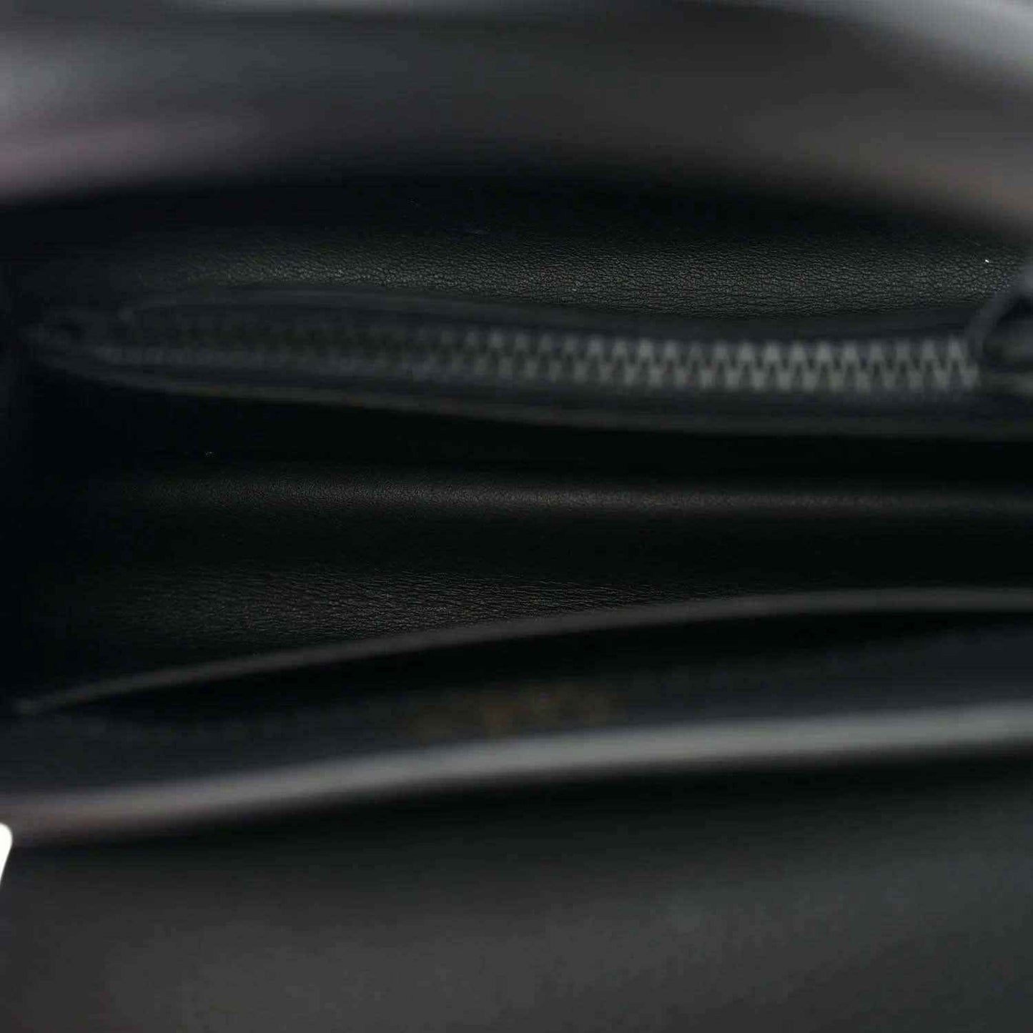 Black mini handbag interior close-up of zipper track and leather lining